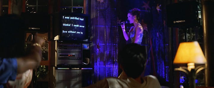 Scene from I Still Know What You Did Last Summer with Jennifer Love Hewitt as Julie James singing I Will Survive at a karaoke bar
