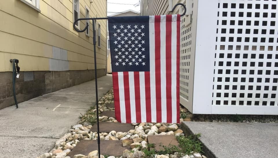 U.S. flag on garden stand (union left, near horizontal bar)