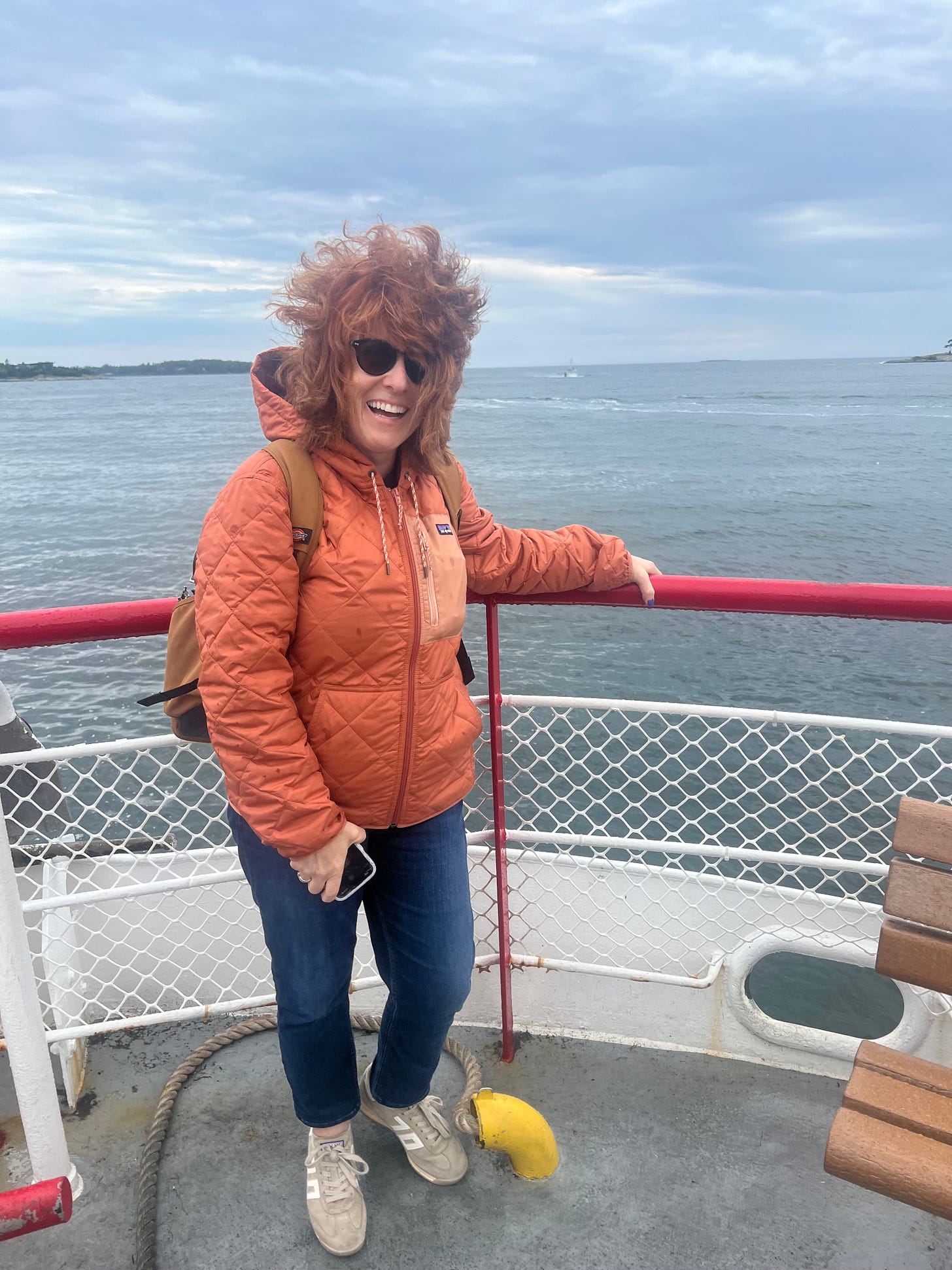 woman on a ferry with her hair blowing in the wind woman on a ferry with her hair blowing in the wind