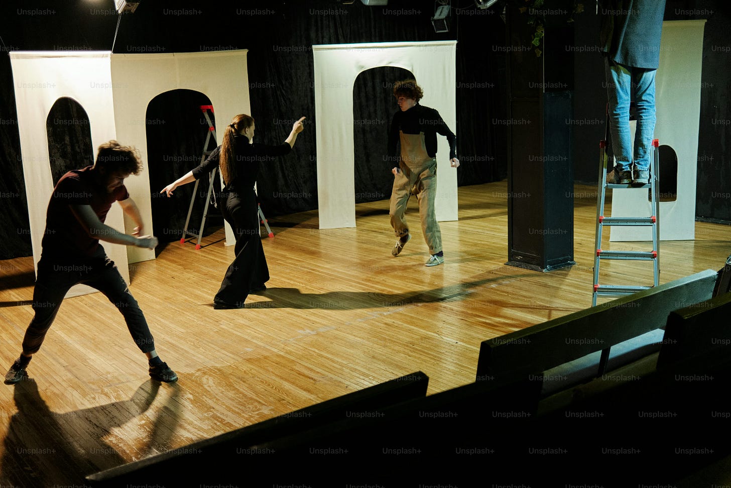 a group of people standing on top of a wooden floor