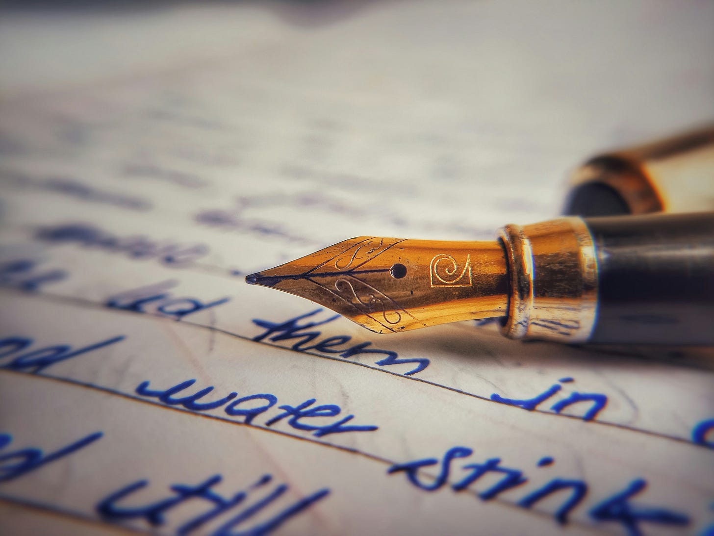 Pen on top of a paper. Photo by Rushaan S on Unsplash.