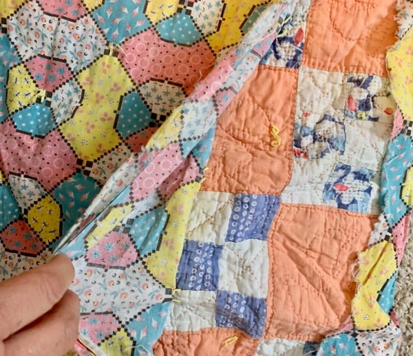 the top layer of the comforter pulled back to reveal a quilt the top layer of the comforter pulled back to reveal a quilt