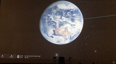 Photographs from a software engineer's overnight sleepover during a hackathon. It includes images of the museum empty at night, the team working together and a photo of earth projected on a screen.