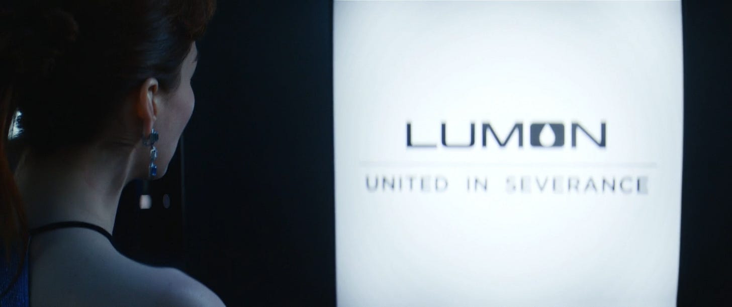 Helly looking at a screen that says "Lumon: United in Severance"