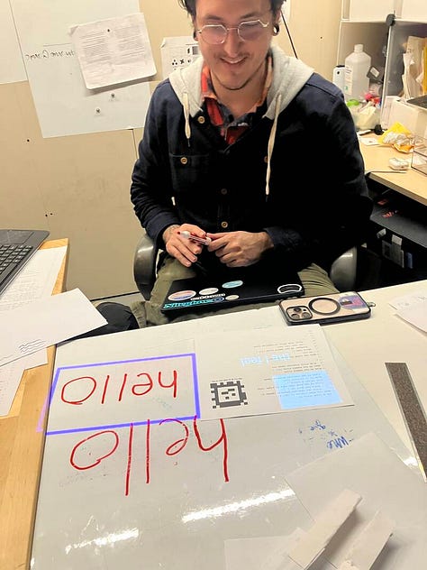 Photos of people around projectors and augmented pieces of paper from the Folk studio