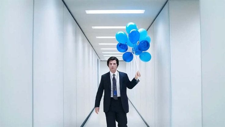 This may contain: a man in a suit and tie is holding blue balloons while walking down a hallway