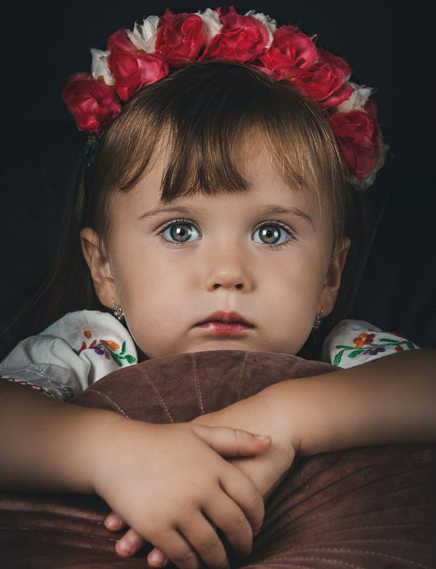 a little girl with a red flower in her hair a little girl with a red flower in her hair