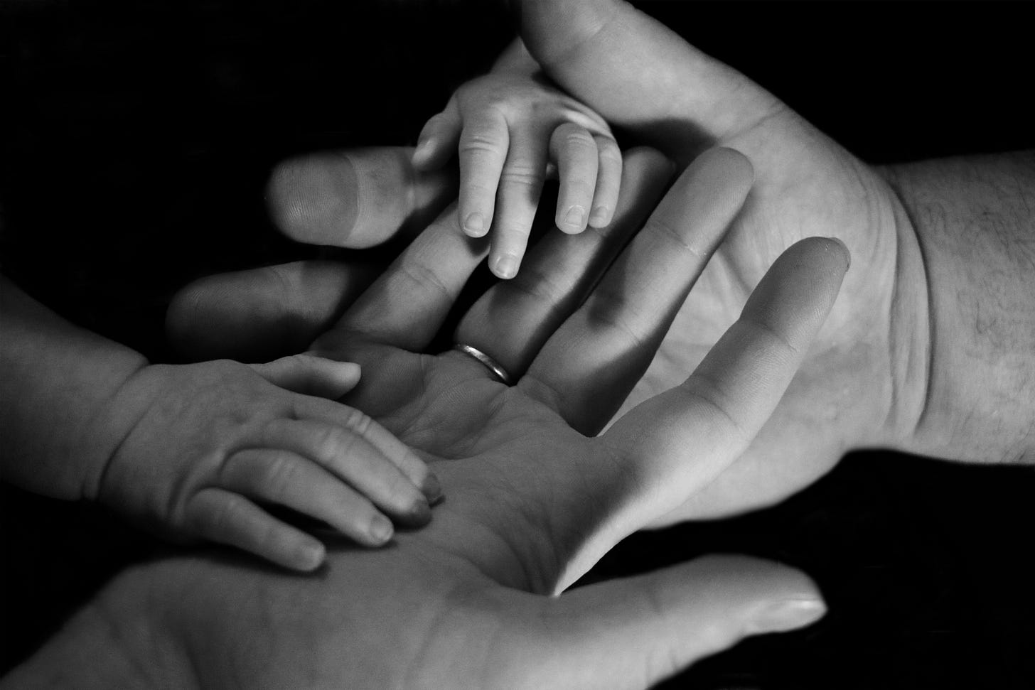 Baby hands on human palm