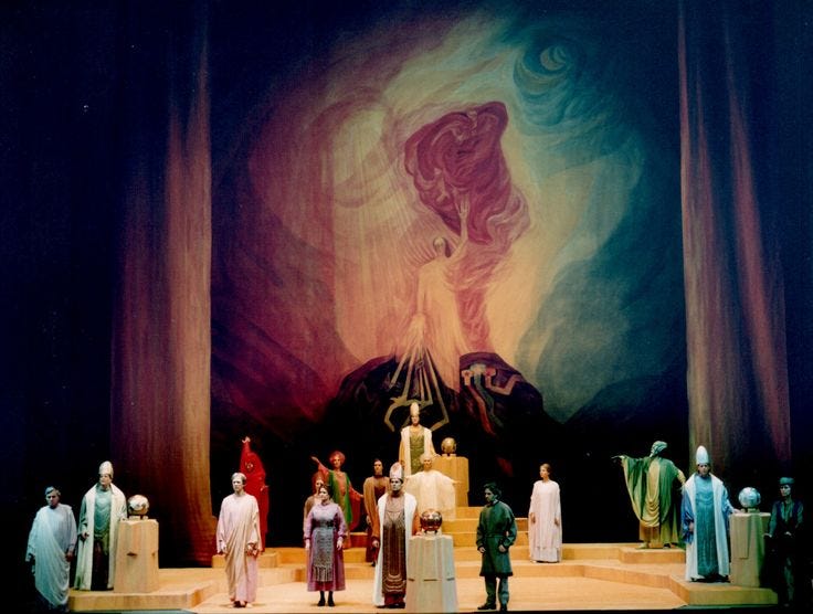 This may contain: a group of people standing on top of a stage next to each other in front of a painting