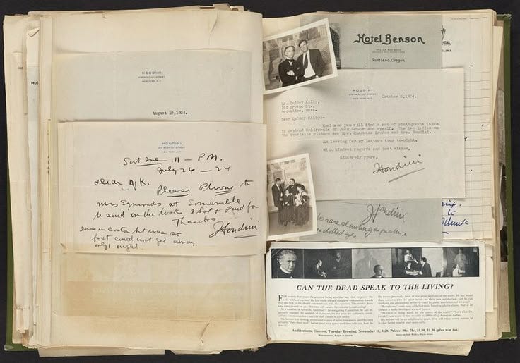 This may contain: an open book with papers and pictures on it