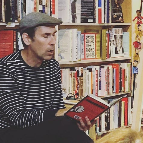 My book laying open atop a sleeping baby, my book next to a cute dog, and me reading me book at a bookstore event