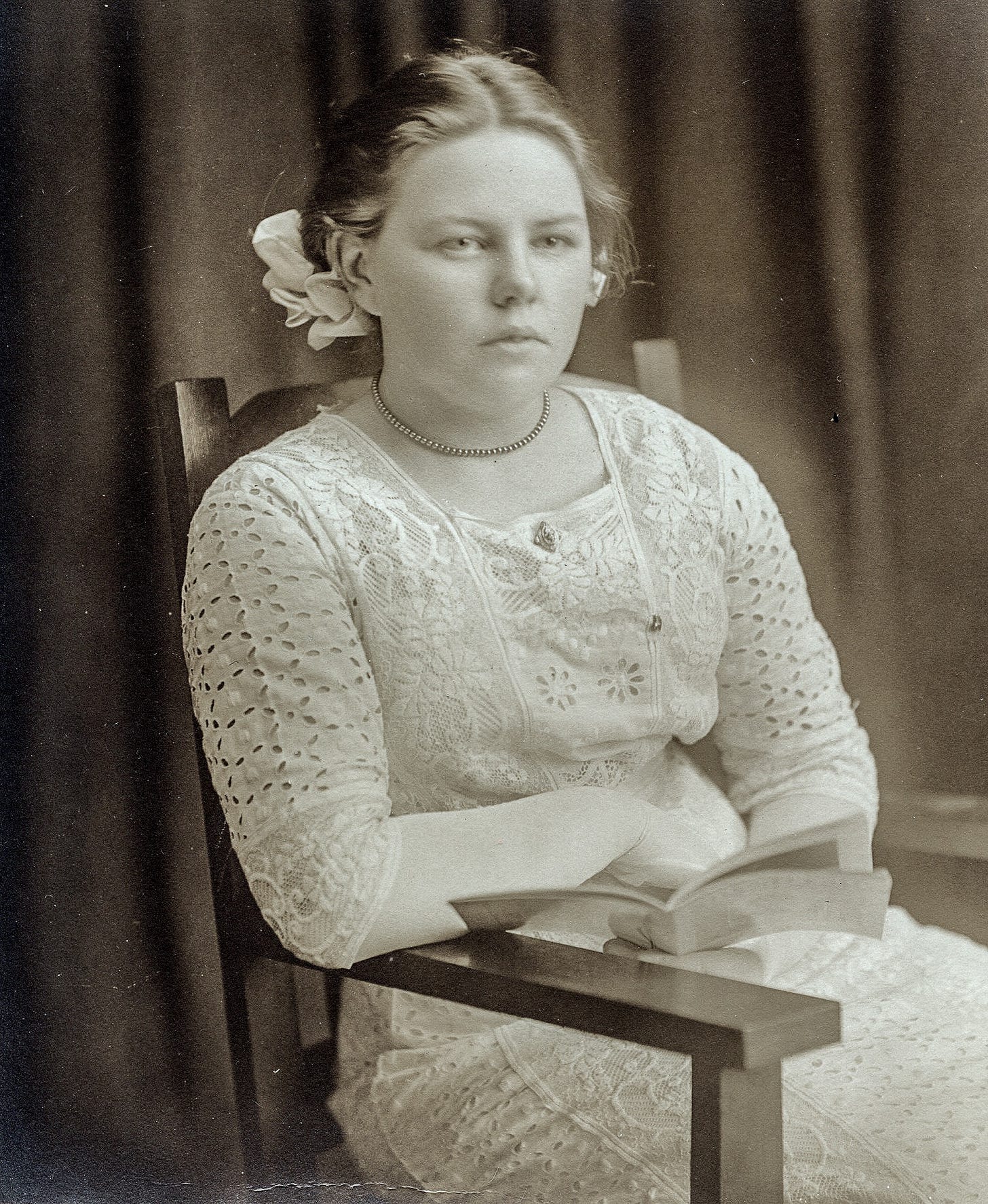 Seated young woman with book
