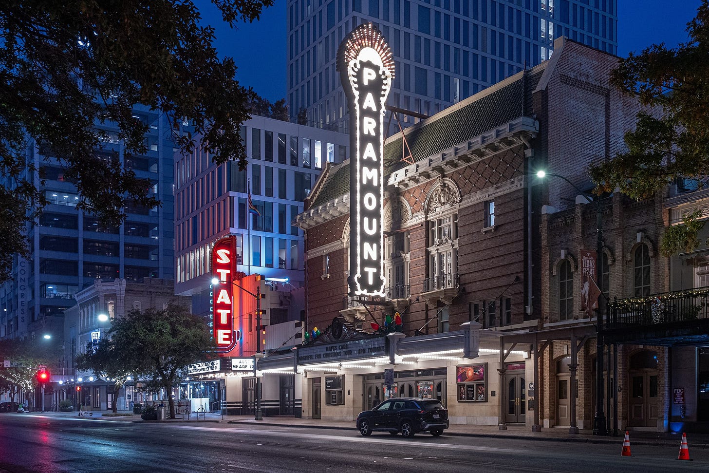 The Paramount and State theatres lit up on Congress Avenue in downtown Austin