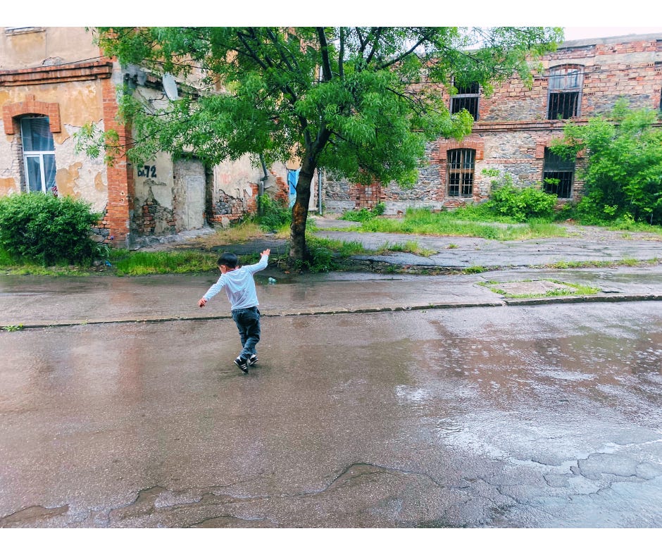 Roma child dancing in the rain