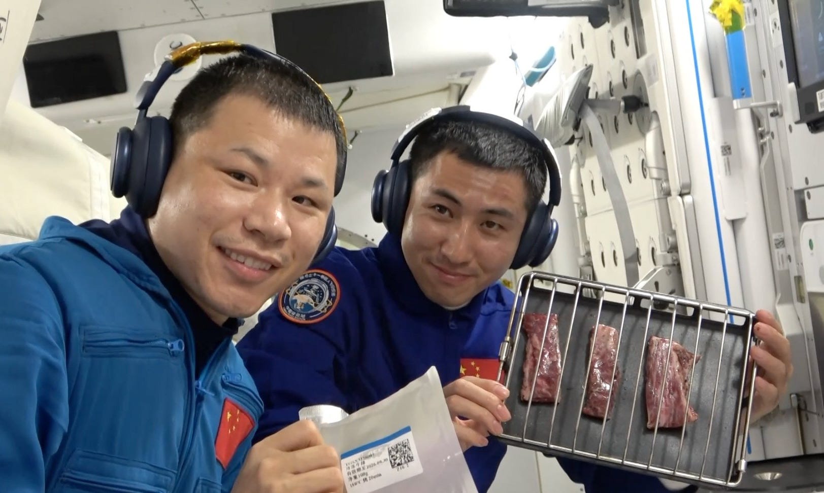 Shenzhou-20’s Wang Jie (left) and Shenzhou-21’s Wu Fei (right) preparing fresh meat for cooking onboard the Tiangong Space Station. Shenzhou-20’s Wang Jie (left) and Shenzhou-21’s Wu Fei (right) preparing fresh meat for cooking onboard the Tiangong Space Station.