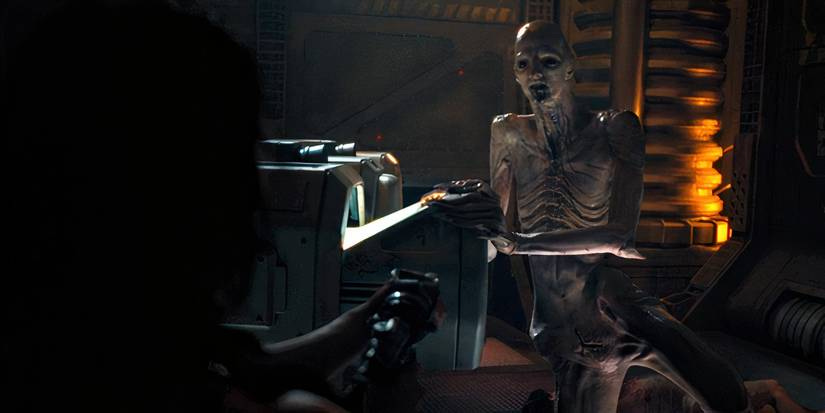 The Offspring looking at Rain holding a gun in Alien: Romulus (2024)