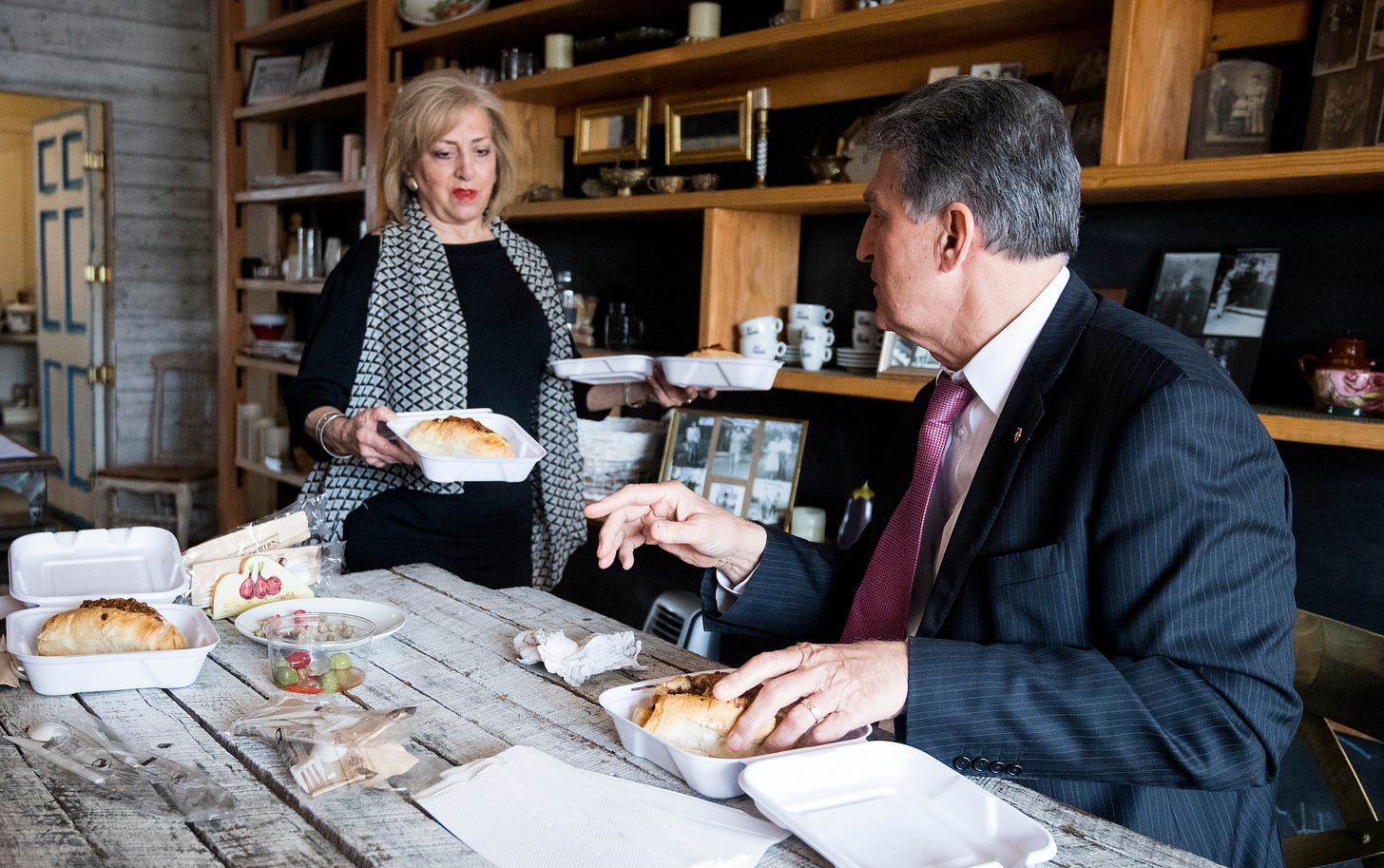 Karen Shannon, owner of the Pepperoni Chic pop up restaurant, serves pepperoni rolls to Sen. Joe Manchin, D-W. Va., on Wednesday, April 11, 2018. (Bill Clark/CQ Roll Call) Karen Shannon, owner of the Pepperoni Chic pop up restaurant, serves pepperoni rolls to Sen. Joe Manchin, D-W. Va., on Wednesday, April 11, 2018. (Bill Clark/CQ Roll Call)