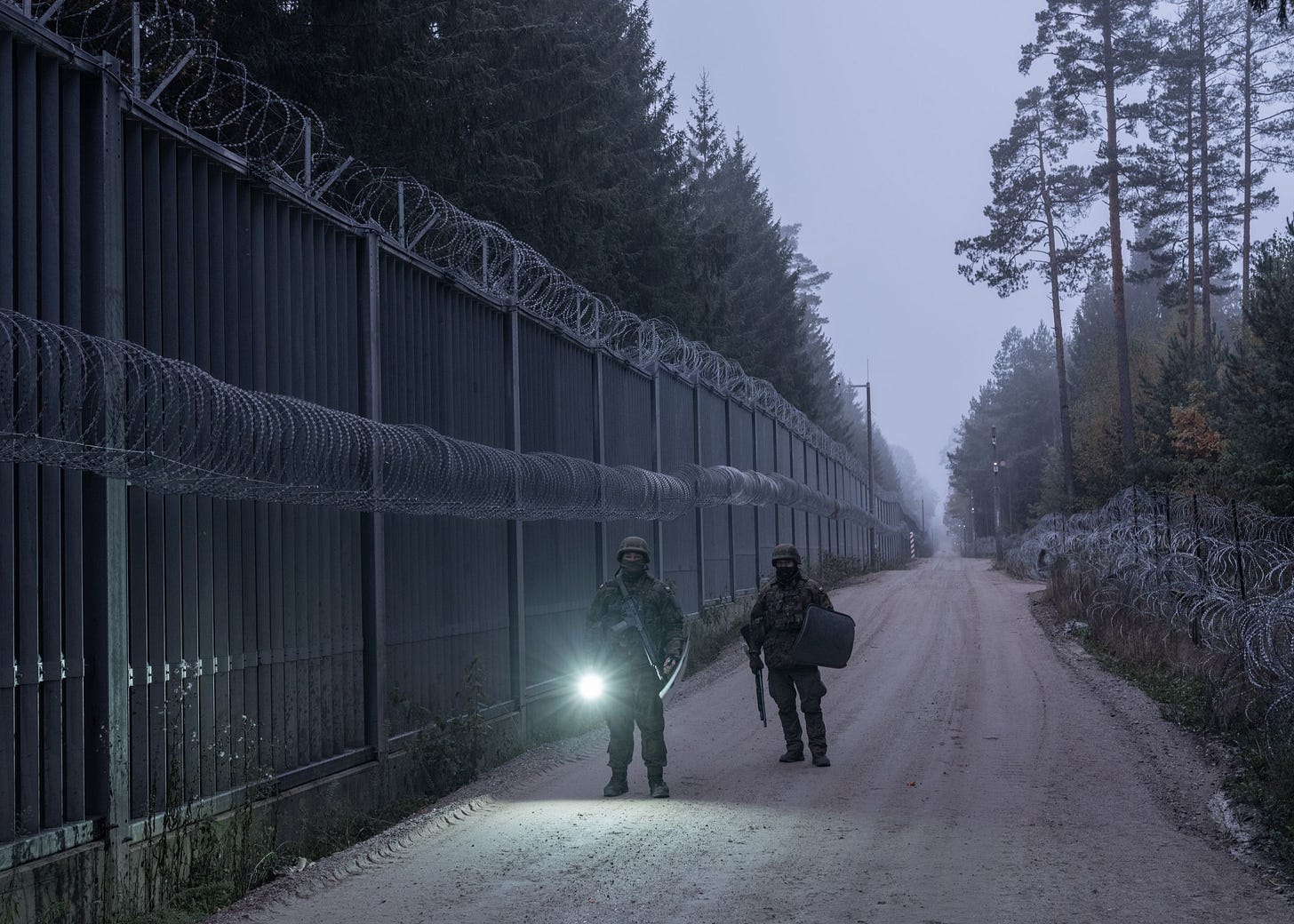People gaurding a fence People gaurding a fence