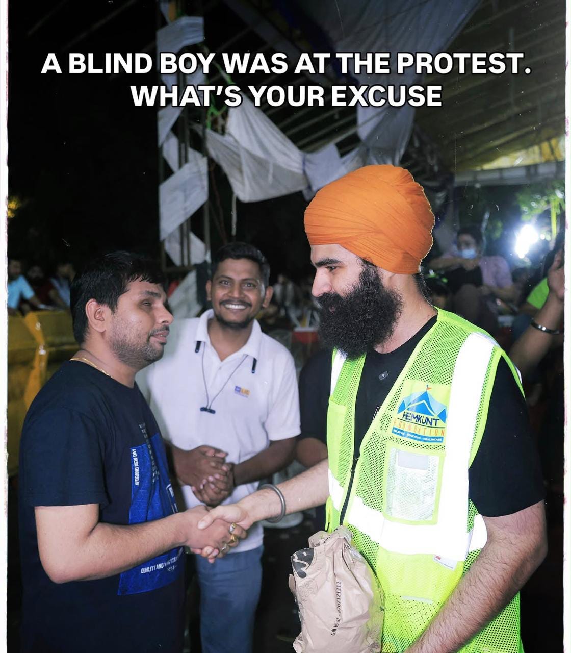 Two men standing with one blind man. One man is shaking hands with the blind man. Caption reads, “a blind boy was at the protest, what’s your excuse?” Two men standing with one blind man. One man is shaking hands with the blind man. Caption reads, “a blind boy was at the protest, what’s your excuse?”