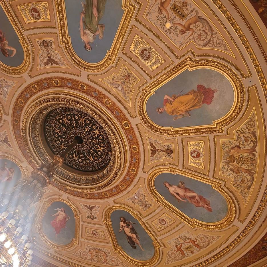 A ceiling with paintings on it

AI-generated content may be incorrect.