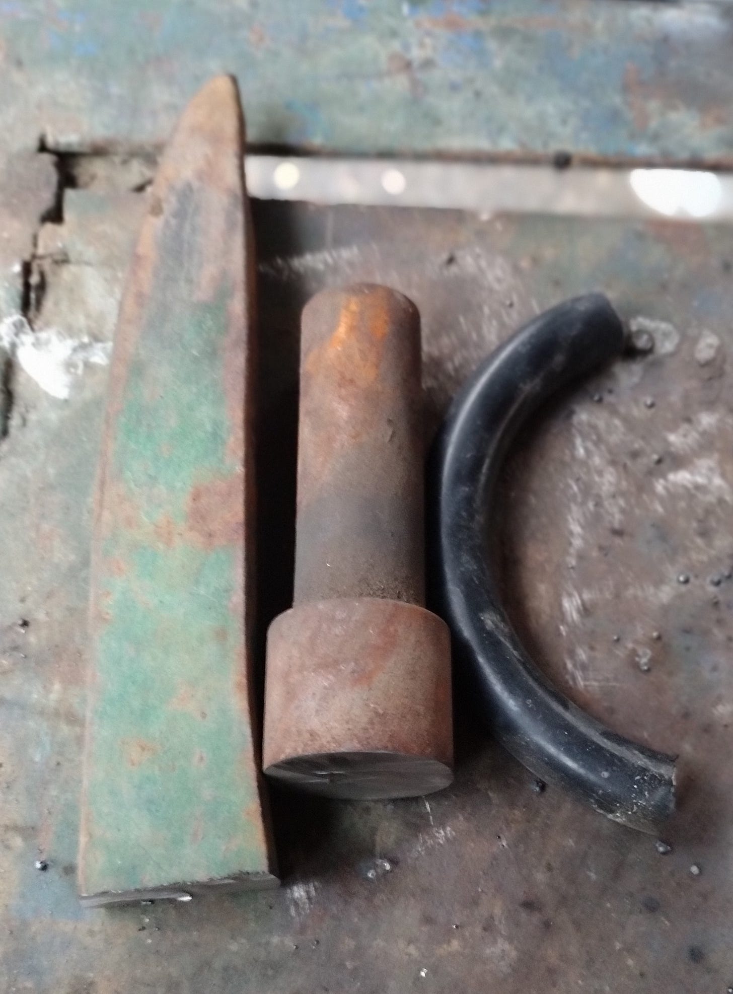 On the left, the pick that that will become the axe. In the center, the crankshaft that wants to be a drift. On the right, the spring destined for chisel-hood.