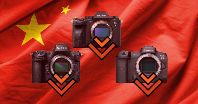 Three digital cameras are arranged in a triangle over a red flag with yellow stars, each featuring a downward-pointing orange chevron. Three digital cameras are arranged in a triangle over a red flag with yellow stars, each featuring a downward-pointing orange chevron.