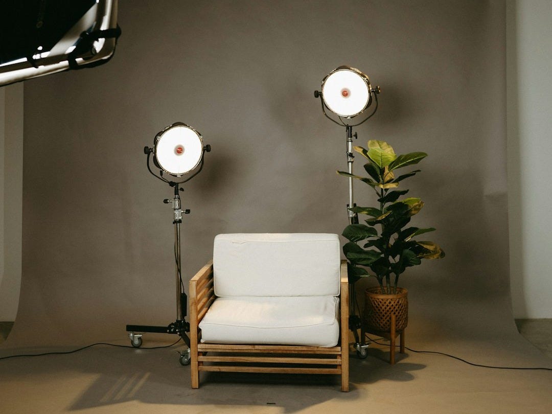 a white chair and a lamp in a room