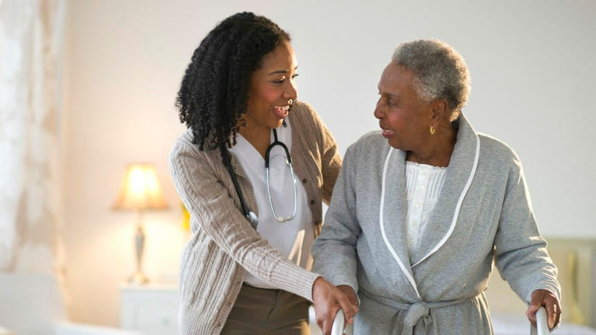 Nurse helping older African American woman