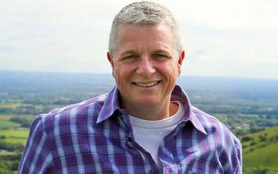 Dr Hall is seen smiling for a portrait in a rural setting Dr Hall is seen smiling for a portrait in a rural setting