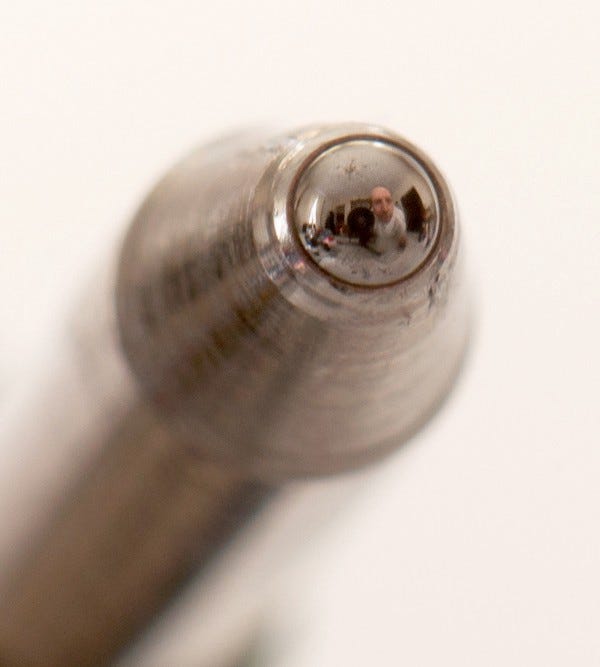 LensAfield reflected in the .4mm ballpoint of a defunct Uniball pen