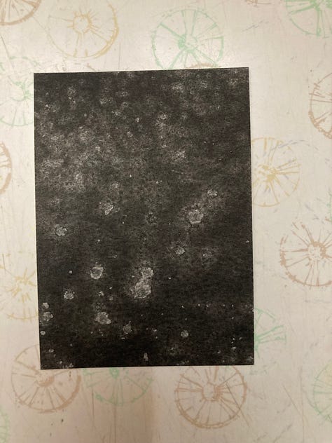 2.5 by 3.5 inch cards painted in black watercolor with random white splotches