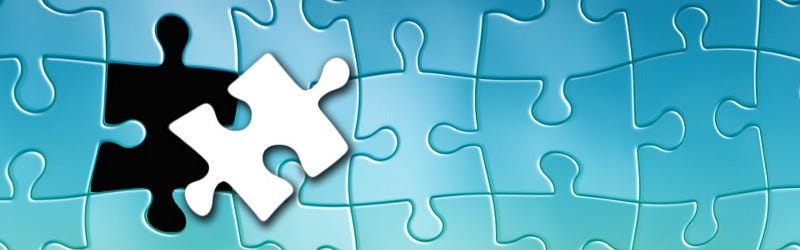 A puzzle with missing piece on top of it.
