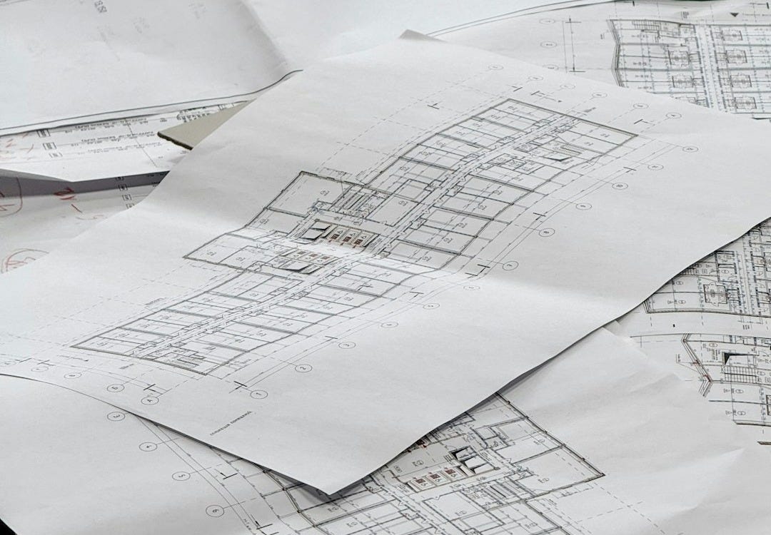 Architectural blueprints spread out on a surface.