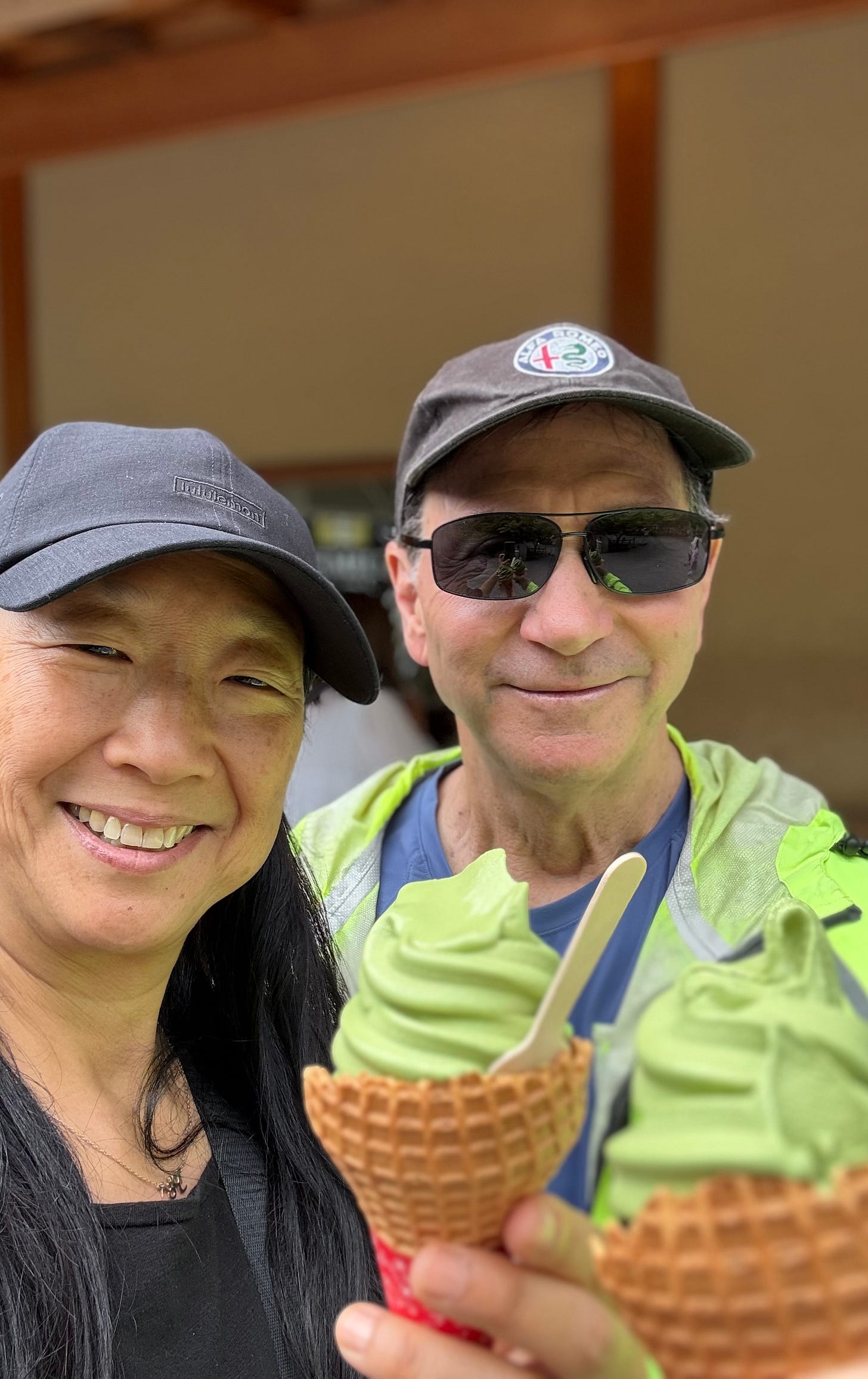 Savitree and Larry holding matcha soft serve cones outside the Golden Temple, Kyoto. Savitree and Larry holding matcha soft serve cones outside the Golden Temple, Kyoto.