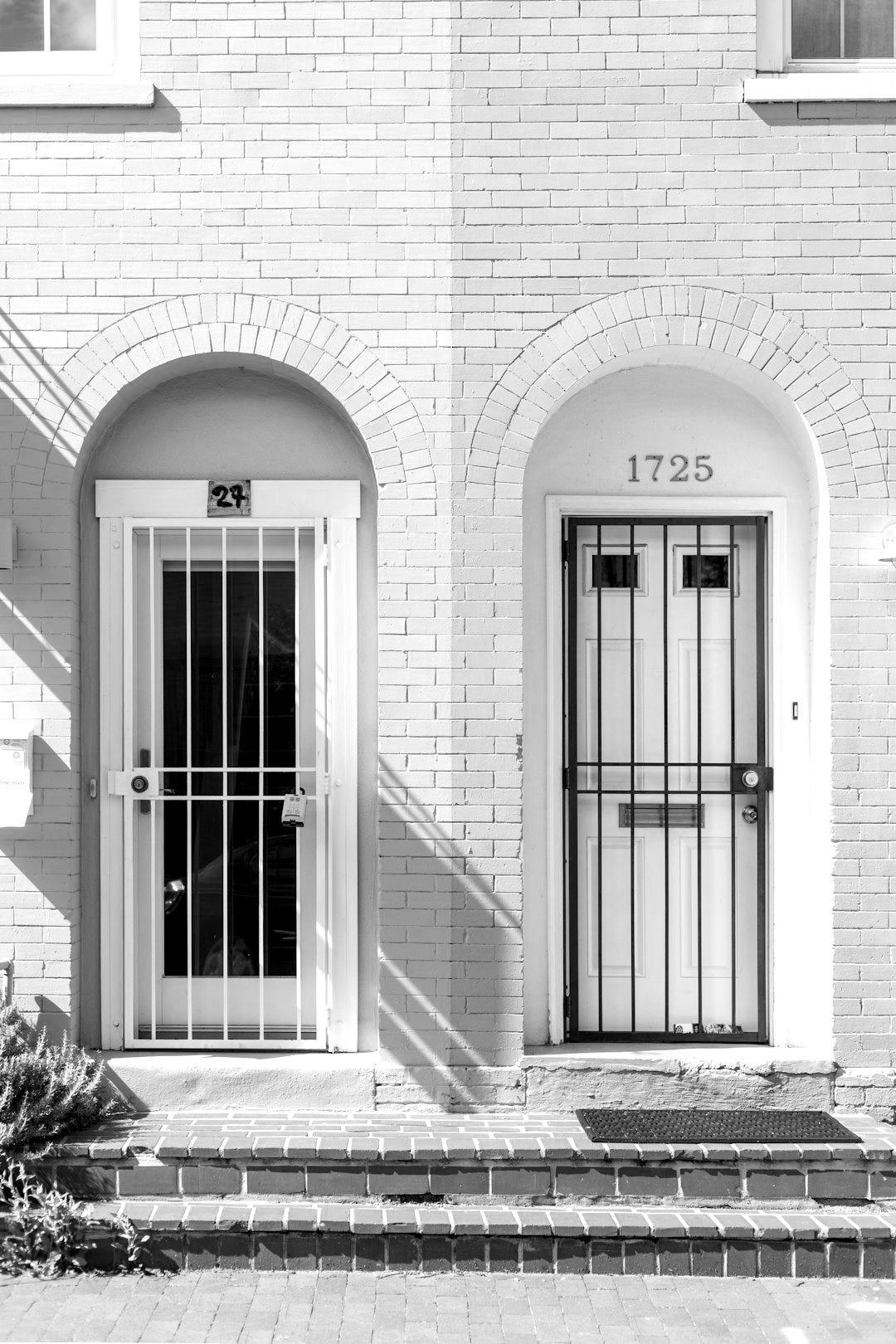 two white wooden doors with grills