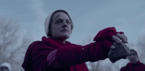 Elisabeth Moss in 'The Handmaid's Tale,' dropping a rock in slow motion. Elisabeth Moss in 'The Handmaid's Tale,' dropping a rock in slow motion.