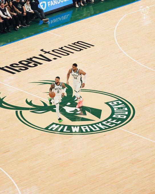 A photo of Damian Lillard and Giannis Antetokounmpo at mid court during Thursday night's game vs. the Lakers at Fiserv Forum.