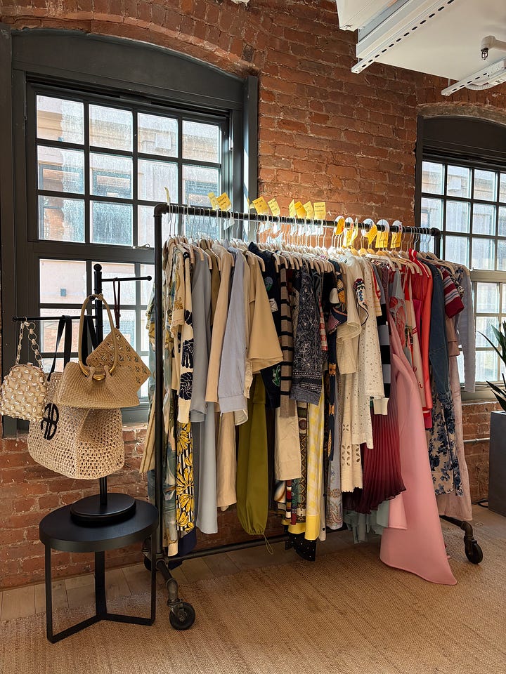 RTR CEO Jennifer Hyman and Chief Merchant Officer, Sarah Tam present the spring trends and feature updates coming to the app over the next few weeks. Rack of clothes and accessories displayed against a sunny window backdrop.