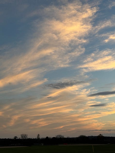 Three sunset pictures of strips of clouds in the sky with an orange glow to them, some trees visible in the foreground but the focus is on the clouds reflecting sunset light.