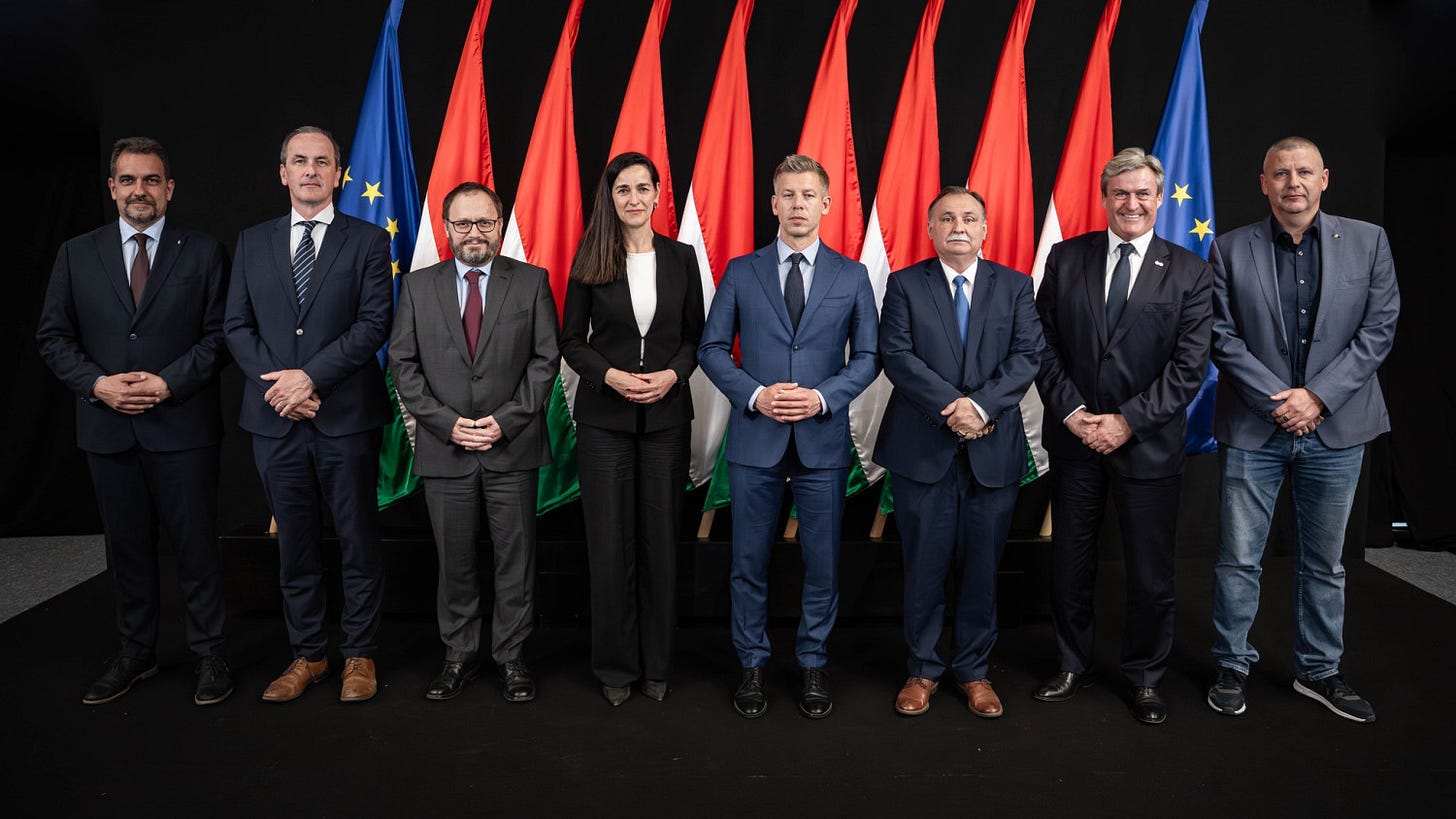 Group portrait of Hungarian government officials standing in front of Hungarian and European Union flags. Group portrait of Hungarian government officials standing in front of Hungarian and European Union flags.