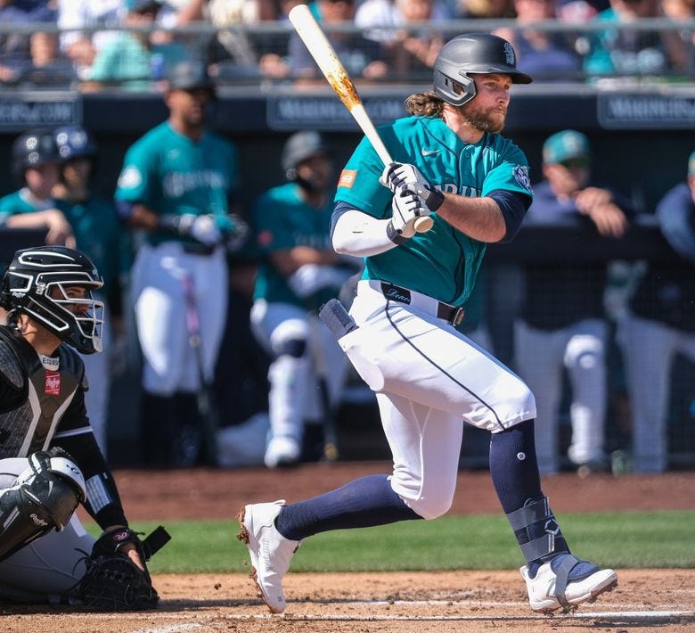 The Mariners’ Brendan Donovan singles during the first inning of a spring training game against the White Sox on Tuesday in Peoria, Ariz. (Dean Rutz / The Seattle Times)