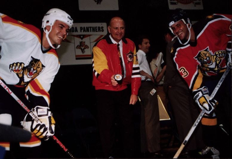 Florida Panthers owner Wayne Huizinga posing with players in the home and away uniforms. Courtesy of the Miami Herald. Photographer A. Brennan Innerarity. Florida Panthers owner Wayne Huizinga posing with players in the home and away uniforms. Courtesy of the Miami Herald. Photographer A. Brennan Innerarity.
