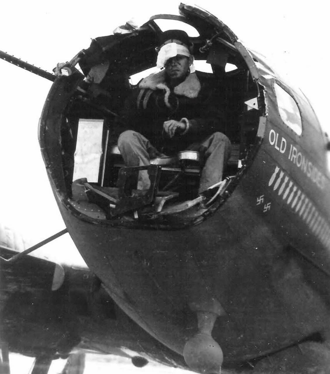 A wounded crewman of the B-17 Flying Fortress 'Old Ironsides' among damage from a mid-air collision over Palermo, Italy, 1943. The plane was later downed by flak, resulting in 6 KIA and 4 POWs.