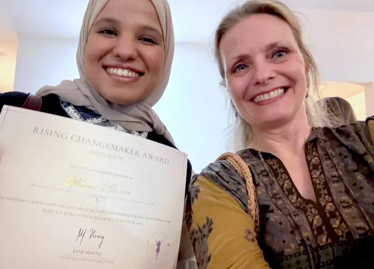 Photo of Alsama holding her certificate, with Meike Ziervogel.