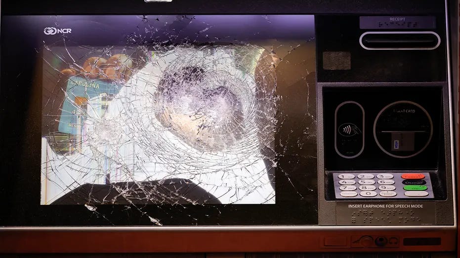 A smashed ATM is seen at a Wells Fargo branch following a protest, late Saturday, Jan. 21, 2023, in Atlanta, in the wake of the death of an environmental activist killed after authorities said the 26-year-old shot a state trooper. 