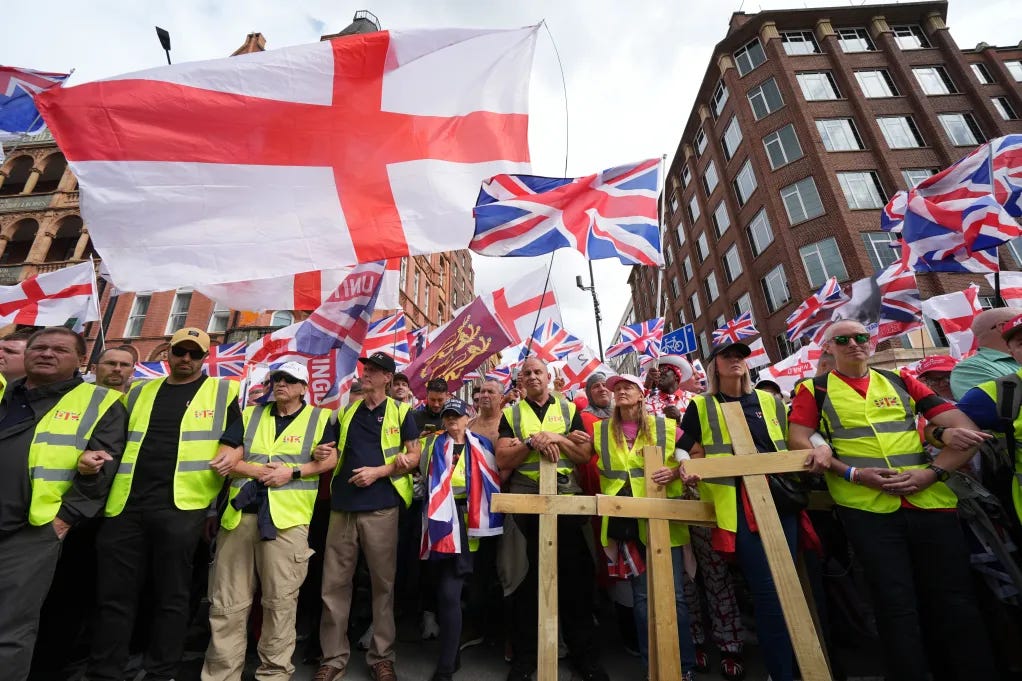 Activists at a Unite the Kingdom march carry crosses and Union flags. Activists at a Unite the Kingdom march carry crosses and Union flags.