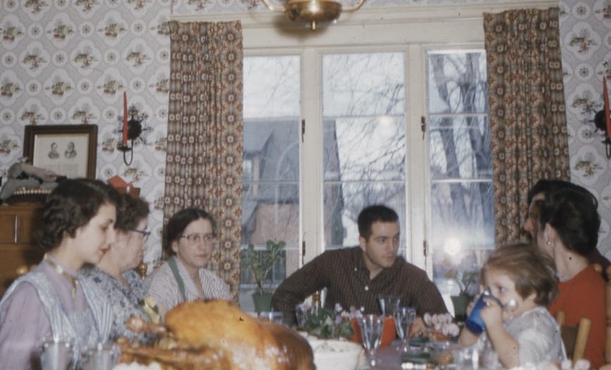 people sitting on dining chair in front of table