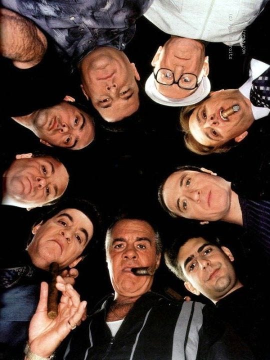 This may contain: a group of men standing in a circle holding their hands together and making funny faces