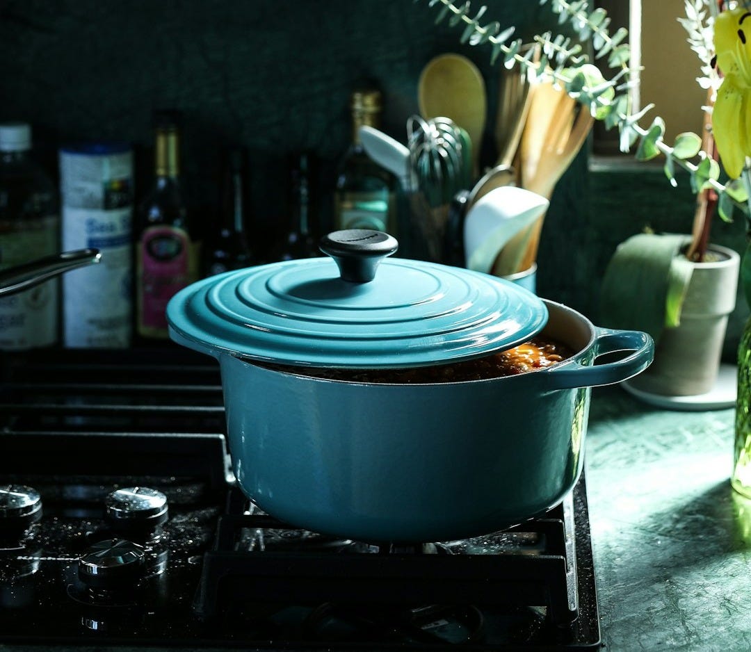 partly opened blue metal pot on stove partly opened blue metal pot on stove