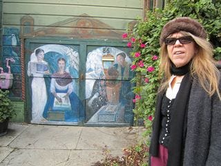 A - Murals - CU Pastricia and painted mural behind her A - Murals - CU Pastricia and painted mural behind her